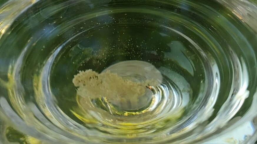 Wine tartar in a glass is not dangerous, you just need to strain it. It probably formed because the wine was at too low a temperature.